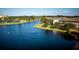 Aerial view of community lake and surrounding buildings and landscape at 9966 Key Haven Rd, Seminole, FL 33777