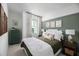 Cozy bedroom with a green accent wall and plenty of natural light at 9966 Key Haven Rd, Seminole, FL 33777