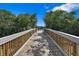 Wooden walkway leads to a relaxing waterfront dock, perfect for enjoying the view at 9966 Key Haven Rd, Seminole, FL 33777