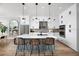 Modern kitchen with white cabinets, island, and stainless steel appliances at 9966 Key Haven Rd, Seminole, FL 33777