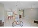 Living room with tiled floor and adjacent dining and kitchen area at 2484 Cover Ln, North Port, FL 34286