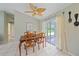 Dining room with wooden table and chairs, and access to a screened porch at 2484 Cover Ln, North Port, FL 34286