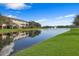 Tranquil lake view with reflection of buildings at 9964 Key Haven Rd, Seminole, FL 33777