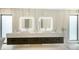 Elegant bathroom with dual sinks, floating vanity, backlit mirrors, and stylish fixtures at 1610 N Lodge Dr, Sarasota, FL 34239