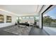 Bright bedroom featuring modern bed, accent chairs, gray rug, and access to the balcony at 1610 N Lodge Dr, Sarasota, FL 34239