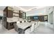Modern dining room with long marble table, sleek cabinetry, and integrated bar area at 1610 N Lodge Dr, Sarasota, FL 34239