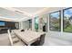 Contemporary dining room featuring a long table, modern art, and views of the outdoors at 1610 N Lodge Dr, Sarasota, FL 34239