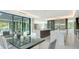 Open-concept dining area with a sleek table, modern decor, and seamless transition to the kitchen at 1610 N Lodge Dr, Sarasota, FL 34239