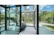 Modern entryway featuring floor-to-ceiling glass, an indoor elevator, and views of the landscaped yard at 1610 N Lodge Dr, Sarasota, FL 34239