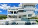 Modern, multi-story home featuring a pool, outdoor kitchen, and multiple balconies at 1610 N Lodge Dr, Sarasota, FL 34239