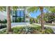 Striking modern home with a grand entrance, featuring a meticulously designed walkway and verdant landscaping at 1610 N Lodge Dr, Sarasota, FL 34239
