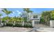 Modern home behind gated entry with lush landscaping offering privacy and curb appeal at 1610 N Lodge Dr, Sarasota, FL 34239