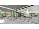 Spacious open floor plan with floor to ceiling glass, leading to the outdoor space and a view of the central courtyard at 1610 N Lodge Dr, Sarasota, FL 34239