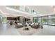 Spacious living room with modern furnishings, a wet bar, and floor-to-ceiling windows at 1610 N Lodge Dr, Sarasota, FL 34239