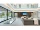 Bright, open living space with modern decor, glass floor, and views of outdoor dining area at 1610 N Lodge Dr, Sarasota, FL 34239
