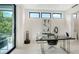 Bright office space with a sleek glass desk, modern decor, and natural light at 1610 N Lodge Dr, Sarasota, FL 34239