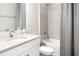 Guest bathroom with shower/tub combo, white vanity, and tiled walls at 2105 Sylvan Lea Dr, Sarasota, FL 34240