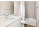 Modern bathroom with white vanity, tiled shower, and wood-look tile floor at 2105 Sylvan Lea Dr, Sarasota, FL 34240