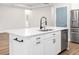 Kitchen island with white quartz countertop, stainless steel sink, and modern black faucet at 2105 Sylvan Lea Dr, Sarasota, FL 34240