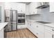 Kitchen with white cabinetry, stainless steel appliances including a double oven, and sleek countertops at 2105 Sylvan Lea Dr, Sarasota, FL 34240