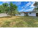 Charming home with a spacious backyard, featuring a large tree and a wooden fence at 818 Padgett Ave, Sarasota, FL 34237
