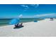 Relaxing beach scene with umbrellas and chairs under a bright sky at 818 Padgett Ave, Sarasota, FL 34237