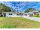 Newly renovated home with a large front yard and driveway at 818 Padgett Ave, Sarasota, FL 34237
