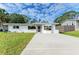 Charming single-story home with a well-manicured lawn and concrete driveway at 818 Padgett Ave, Sarasota, FL 34237