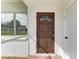 Dark wood front door with a glass insert and smart lock at 818 Padgett Ave, Sarasota, FL 34237