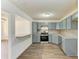 Updated kitchen with gray cabinets, granite counters, and stainless steel appliances at 818 Padgett Ave, Sarasota, FL 34237