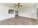 Open concept living room with wood-look floors and kitchen view at 818 Padgett Ave, Sarasota, FL 34237