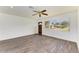 Living room with wood-look floors, ceiling fan, and front door access at 818 Padgett Ave, Sarasota, FL 34237