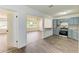 Bright living room with hardwood floors and a view into the kitchen at 818 Padgett Ave, Sarasota, FL 34237