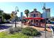 Quaint outdoor cafe with red umbrellas and lush landscaping at 818 Padgett Ave, Sarasota, FL 34237