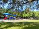Play area with shaded structures, slides, and playground equipment at 818 Padgett Ave, Sarasota, FL 34237