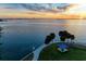 Stunning sunset over the water, palm trees, and waterfront park at 818 Padgett Ave, Sarasota, FL 34237