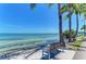 Scenic waterfront view with a park bench, palm trees, and a bridge in the distance at 818 Padgett Ave, Sarasota, FL 34237
