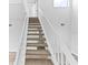 Modern staircase with carpeted steps and white railing at 2955 N Beach Rd # A531, Englewood, FL 34223