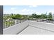 Private balcony overlooking a tree-lined street and partial ocean view at 2955 N Beach Rd # A531, Englewood, FL 34223