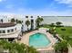 Community pool with surrounding patio and lounge chairs, offering waterfront views at 2955 N Beach Rd # A531, Englewood, FL 34223