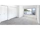 Well-lit bedroom featuring grey carpeting and double closets at 2955 N Beach Rd # A531, Englewood, FL 34223