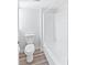 Simple bathroom with bathtub, toilet, and light wood-look vinyl flooring at 2955 N Beach Rd # A531, Englewood, FL 34223
