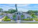 Modern home with gray brick exterior, white fence, and landscaped yard at 3502 Bahia Vista St, Sarasota, FL 34239