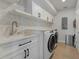 Clean laundry room with white cabinets and new washer/dryer at 3502 Bahia Vista St, Sarasota, FL 34239