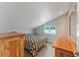 Bright bedroom with a sloped ceiling and rustic wooden furniture at 3502 Bahia Vista St, Sarasota, FL 34239