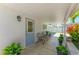 Covered patio with seating and potted plants, offering outdoor space at 3502 Bahia Vista St, Sarasota, FL 34239