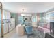 Charming kitchenette features white cabinetry, a breakfast bar, and a cozy sitting area at 3502 Bahia Vista St, Sarasota, FL 34239