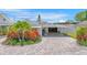 Front view of house with a large driveway and landscaping at 3502 Bahia Vista St, Sarasota, FL 34239