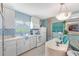 Well-equipped kitchen with white cabinets, a microwave, and a cooktop at 3502 Bahia Vista St, Sarasota, FL 34239