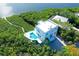 Stunning aerial view showcasing a waterfront home with private pool at 5444 Gulf Of Mexico Dr, Longboat Key, FL 34228